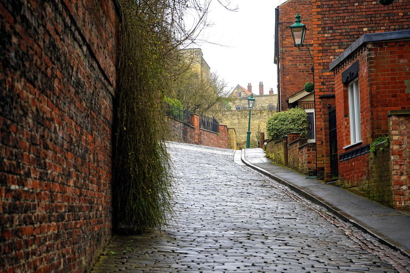 travel, street lamps, building exterior, urban, highway, built structure, murky, brick wall, route, wall, daylight, no people, gloomy, brick, the way forward