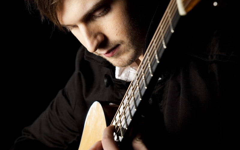 musician, guitar, young adult, musical equipment, music, plucking an instrument, one person, indoors, young men, artist, black background, fingers, performer