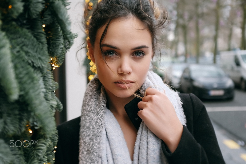 close-up, front view, one Person, black coat, cute, tree, christmas, portrait, contemplation, looking at camera, warm clothing, brunette, brown Hair, lifestyles