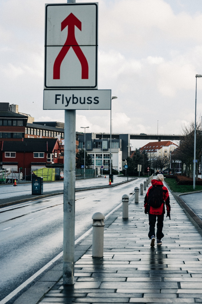 way, full length, street, railing, cloud - sky, footwear, day, road sign, built structure, daytime, nature, rain, handrail, coat, architecture, overcoat