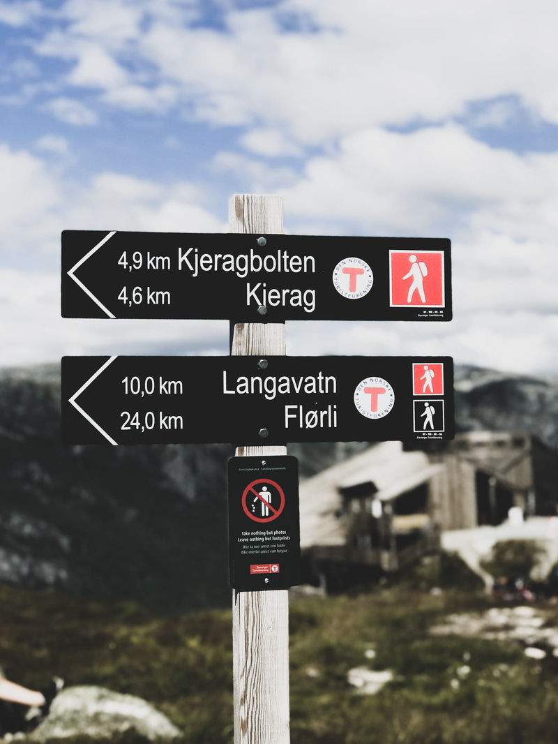 2K, road, symbol, communication, cell phone, signage, outdoors, mobile phone, white, electronics, hand-held computer, sky, focus on foreground, information