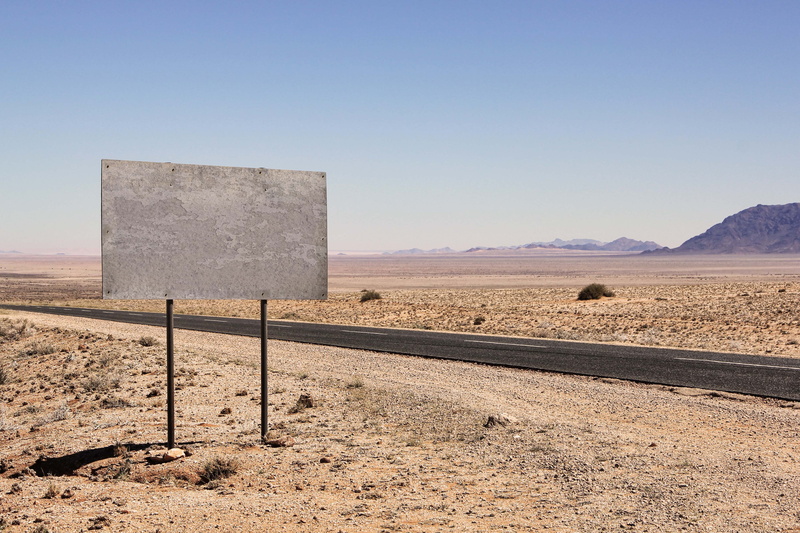 desert, no people, information boards, tranquility, semi-arid, sign, arid Climate, tranquil scene, carriageway, direction, sky, dry, note, clear sky, non-urban scene