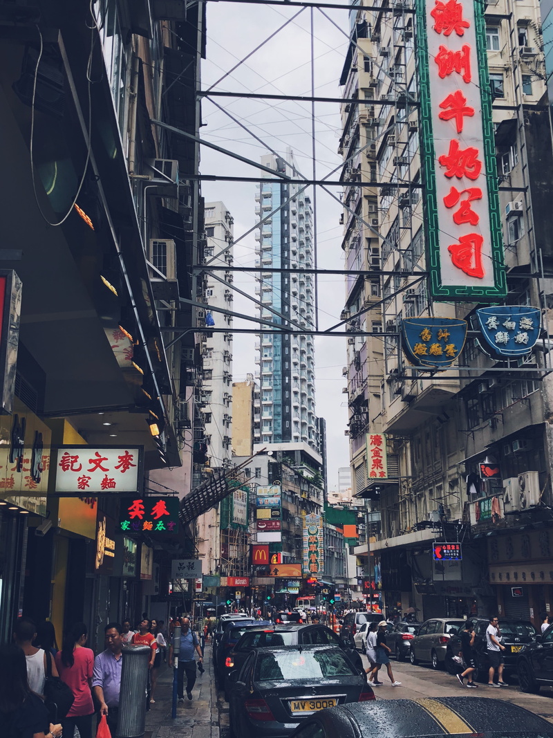 town, motor vehicle, electricity, architecture, built structure, urban, office building exterior, sign, road, downtown, skyscraper, person, men, city life