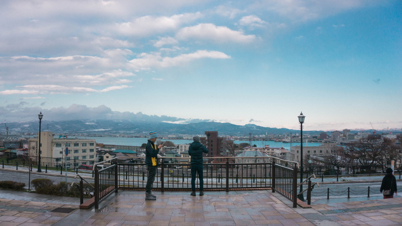 asian, buildings, mountains, men, 5K, building exterior, architecture, cloud - sky, cityscape, day, winter, railing, leisure activity, mountain, sapporo