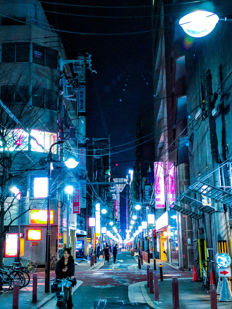 street light, group of people, transportation, lighting equipment, illuminated, street, lifestyles, electricity, light, the way forward, real people, building exterior