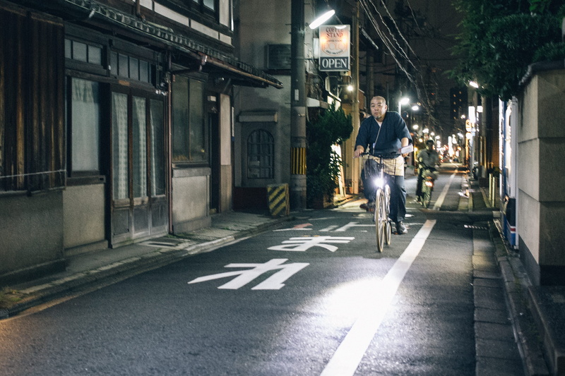street, young adult, osaka prefecture, illuminated, communication, lifestyles, city, road, japan, symbol, sign, casual clothing, night, built structure