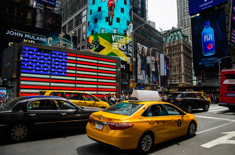 yellow, buildings, traffic, built structure, bus, transportation, American flag, office building exterior, business, time, building exterior, urban, outdoors