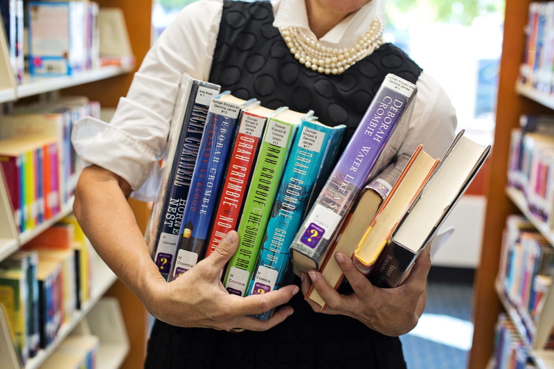 variation, publication, indoors, books, shelf, women, study, human hand, bookshelf, human body part, one person, consumerism, choice, book, lifestyles