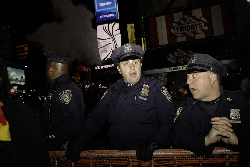 portrait, government, standing, waist up, uniform, cops, real people, men, hat, time square, people, night, looking at camera, front view, times square