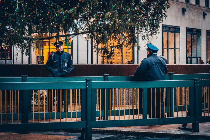 outdoors, lifestyles, sitting, railing, people, built structure, city, uniform, standing, rear view, winter, protect, leisure activity, plant, architecture