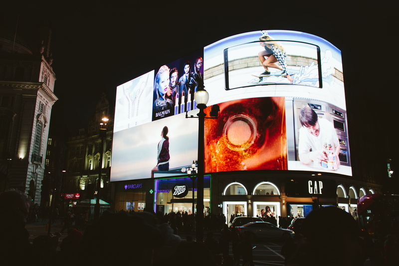motion, lifestyles, leisure activity, city, london, street, advertising, communication, display, large group of people, built structure, illuminated, men