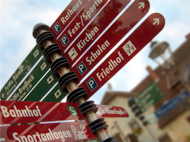 red, text, church, festival site, sign, school, shield, focus on foreground, architecture, metal, town hall, western script, communication, non-western script