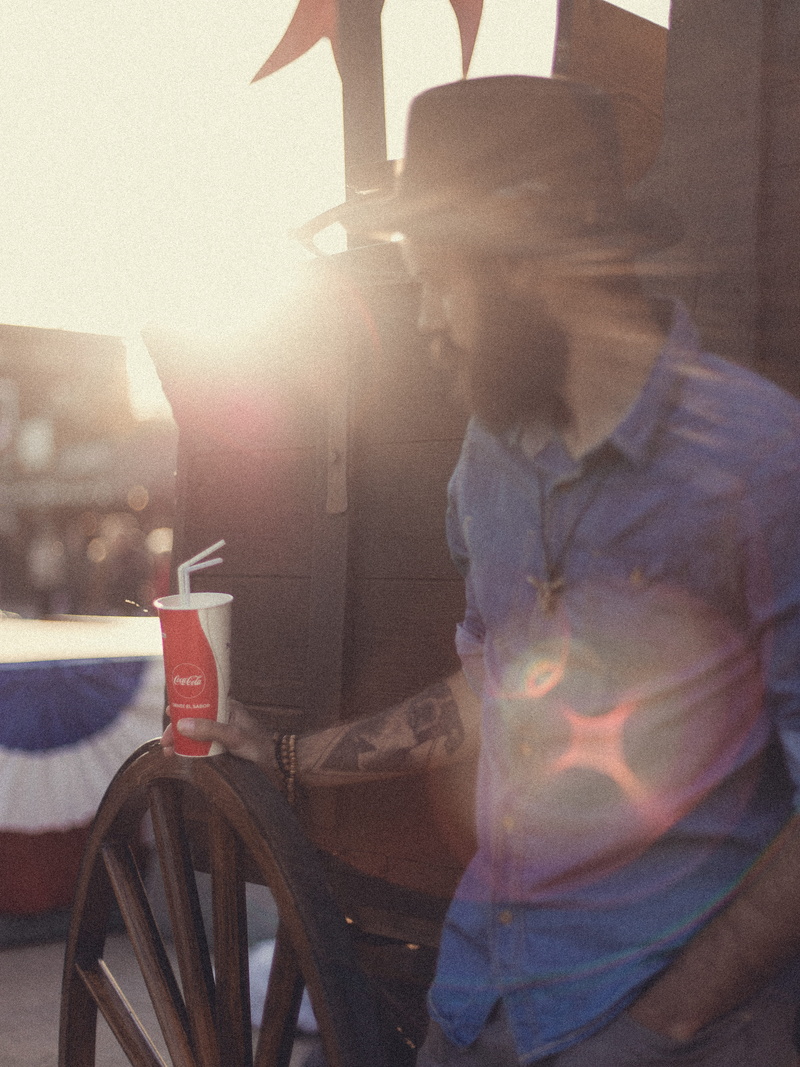 juice, three quarter length, activity, mode of transportation, person, coke, occupation, coca, wearing, clothing, people, cocacola, sitting, human, transportation