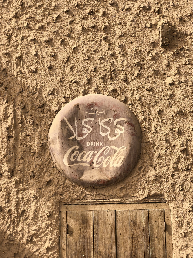 text, soil, architecture, non-western script, egypt, day, cocacola, weathered, ground, sphere, sign, capital letter, crystal, script, emblem, glass, wood - material
