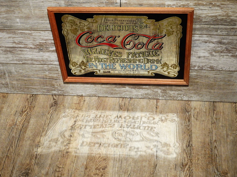 art and craft, coke, text, advertising sign, logo, advertising, coca cola, carving, carving - craft product, non-western script, wood - material, day, indoors