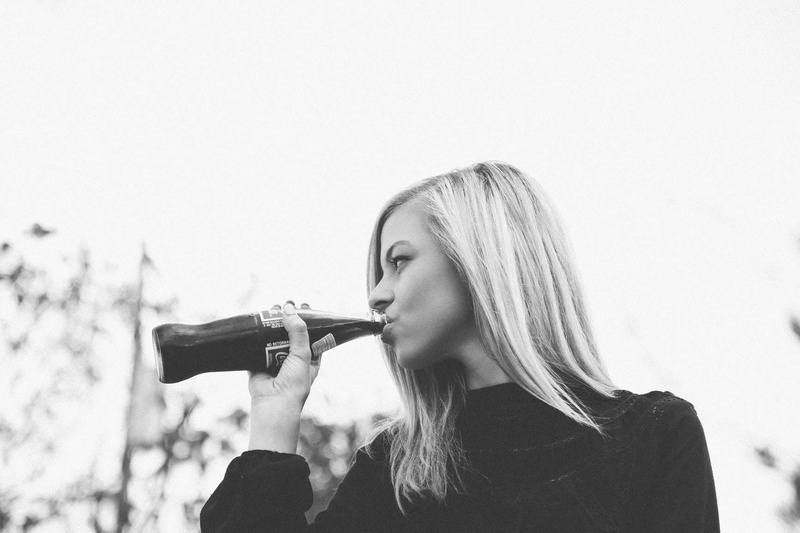 real people, teenager, portrait, refreshing, leisure activity, bottle, looking, women, lifestyles, long hair, young adult, black, holding, blond hair, cola