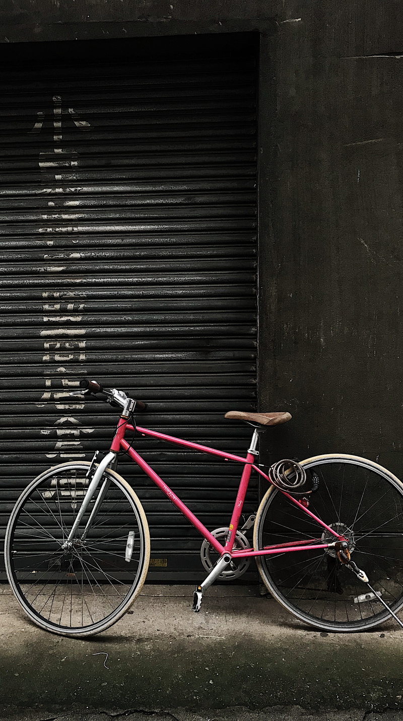 taito city, no people, built structure, navy, machine, apparel, land vehicle, cruiser, bike, pink, wall - building feature, day, mode of transportation