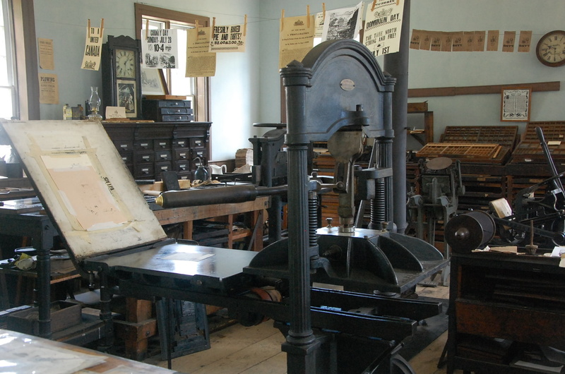 table, newspaper, machinery, wood - material, architecture, museum, metal, black, dresser, old, daily, history, equipment, near, factory, hanging, built structure