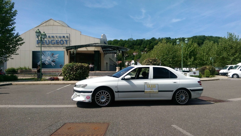 transportation, street, car, mode of transportation, taxi 2, peugeot 406, architecture, parking, road, taxi movie car replica, outdoors, tree, day, sunlight