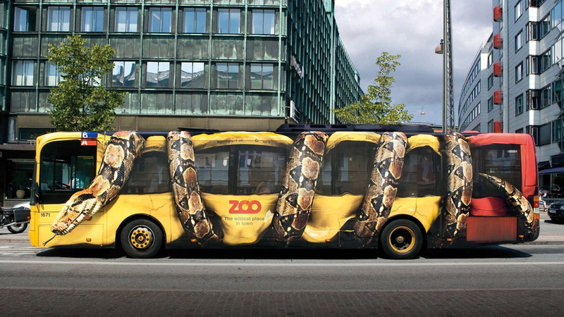 day, road, nature, yellow, transportation, land vehicle, snake, architecture, commercial, mode of transportation, tree, advertisements, building exterior