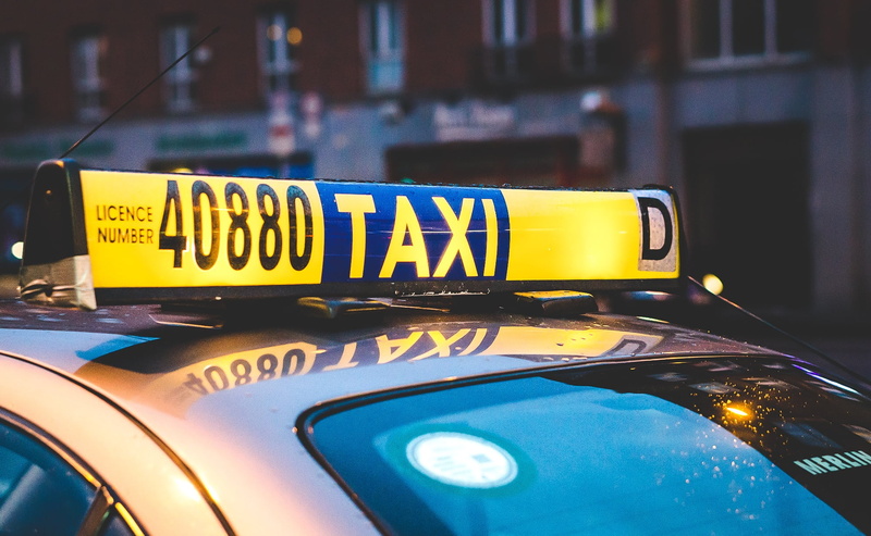 mode of transportation, focus on foreground, day, western script, automobile, communication, car, sign, light, motor vehicle, transport, vehicle, yellow