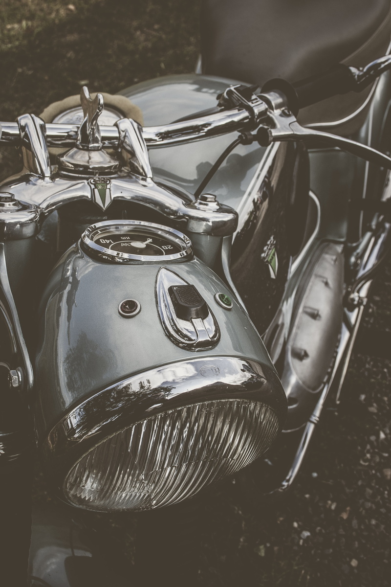 grey, parking, no people, outdoors, motorcycle, mode of transportation, close-up, transportation, high angle view, metal, silver colored, headlight, chrome