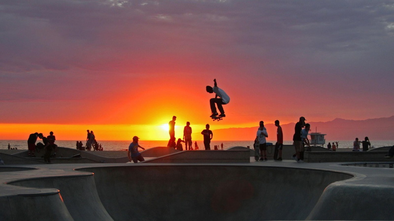 lifestyles, mid-air, large group of people, outdoors, orange color, group of people, california, nature, skateboarding, people, venice, men, beach, silhouette