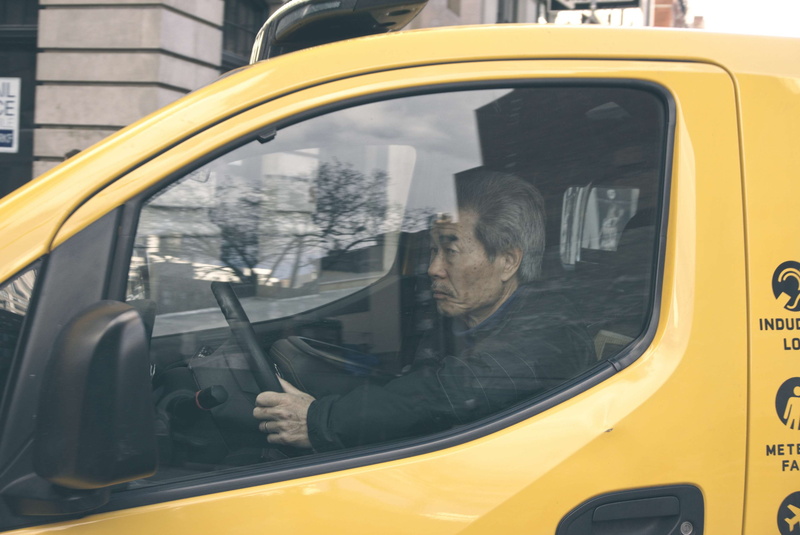 one person, rain, day, men, new york city, people, newspaper, transparent, window, public transportation, street photo, glass - material, land vehicle