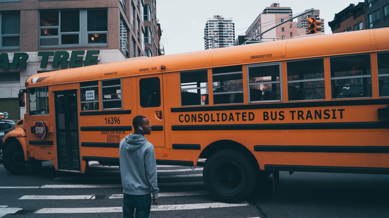 real people, buses, orange color, mode of transportation, incidental people, 5K, transportation, building exterior, land vehicle, photography, school bus
