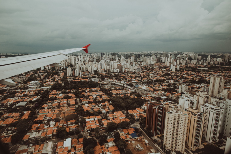 aerial view, scenery, building exterior, day, office building exterior, cidade, travel, sky, flag, nature, cloud - sky, patriotism, skyscraper, wing airplane