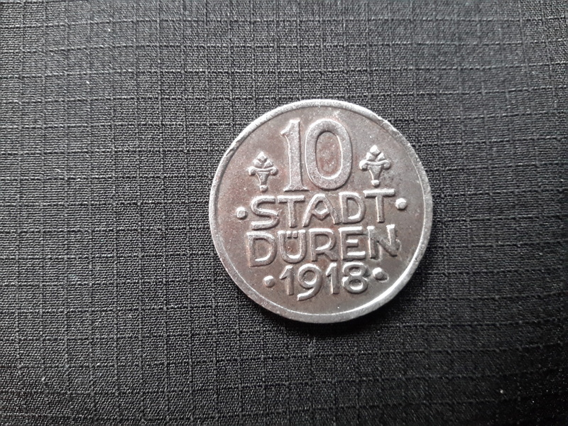 pattern, western script, high angle view, coin, stadt, geometric shape, dueren, no people, 2K, communication, text, directly above, textile, circle, art and craft