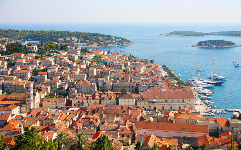 sky, building, nautical vessel, outdoors, sea, townscape, residential district, built structure, water, high angle view, mode of transportation, hvar, transportation