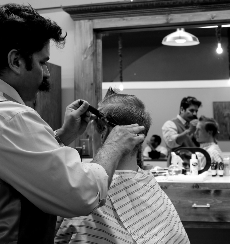 grayscale, 2K, male, side view, hairdresser, hairstyle, lifestyles, barber shop, hair, haircut, two people, young men, mid adult, scissors, holding, reflection