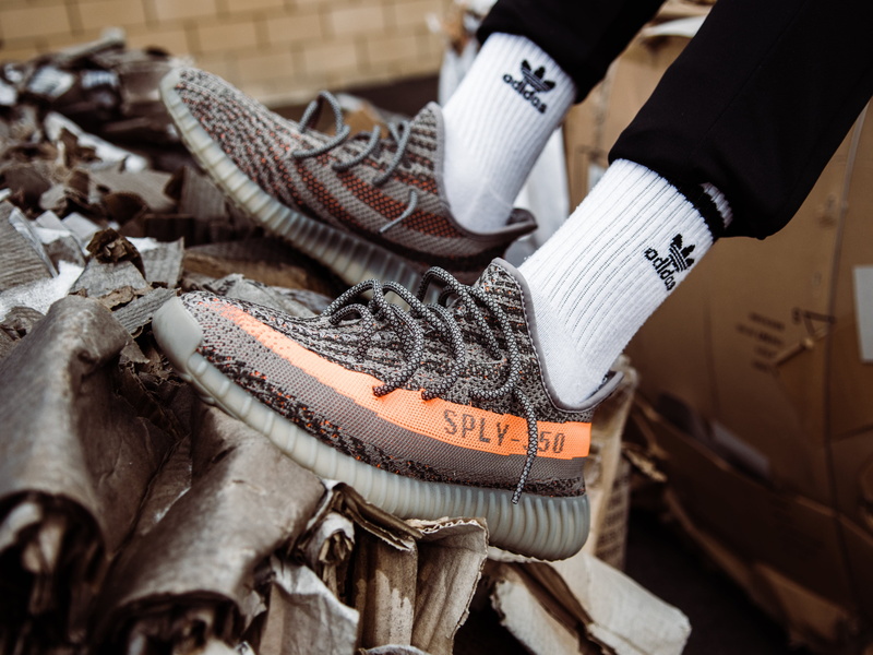 indoors, protective glove, shoe, one person, wood - material, person, v, human hand, sock, white, selective focus, adidas, wearing, textile, orange, business
