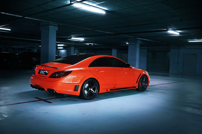 lighting equipment, AMG, luxury, indoors, sedan, German Special Customs, orange, industry, mode of transportation, motor vehicle, garage, parking lot, red