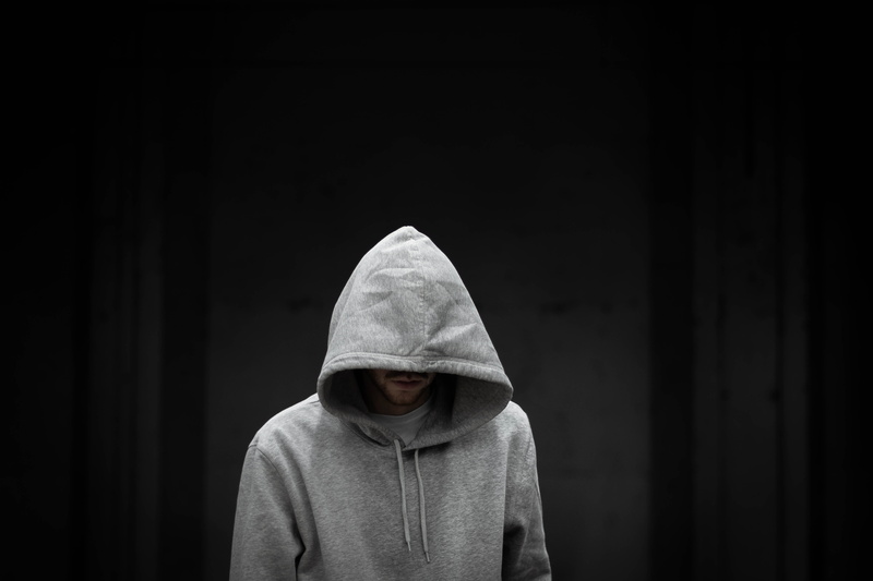 night life, indoors, sleeve, symbol, unrecognizable person, hood, hooded shirt, brick, teenager, cylinder, sweater, photography, men, standing, human, obscured face
