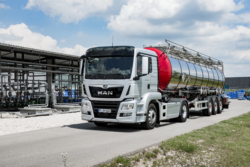 land vehicle, commercial land vehicle, outdoors, vehicle, nature, semi-truck, business, built structure, industry, motor vehicle, road, cloud - sky, transportation