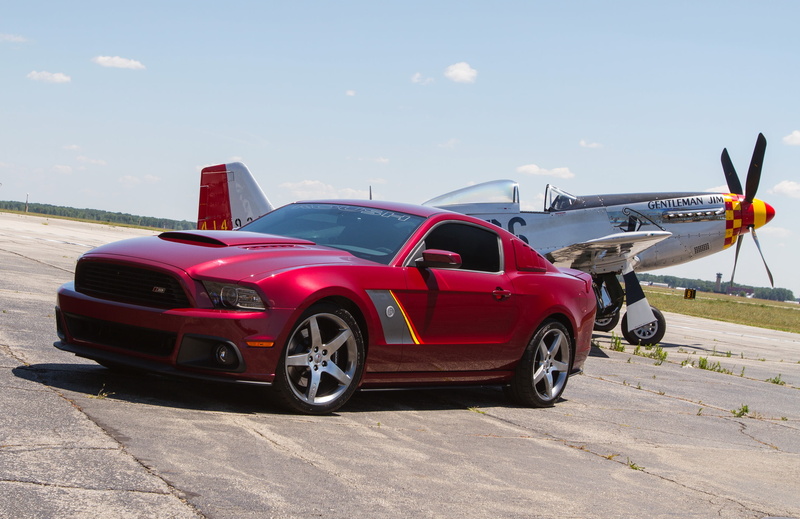sunlight, no people, red, vintage car, transportation, aircraft, blue, airport runway, car, outdoors, luxury, air vehicle, coupe, mode of transportation