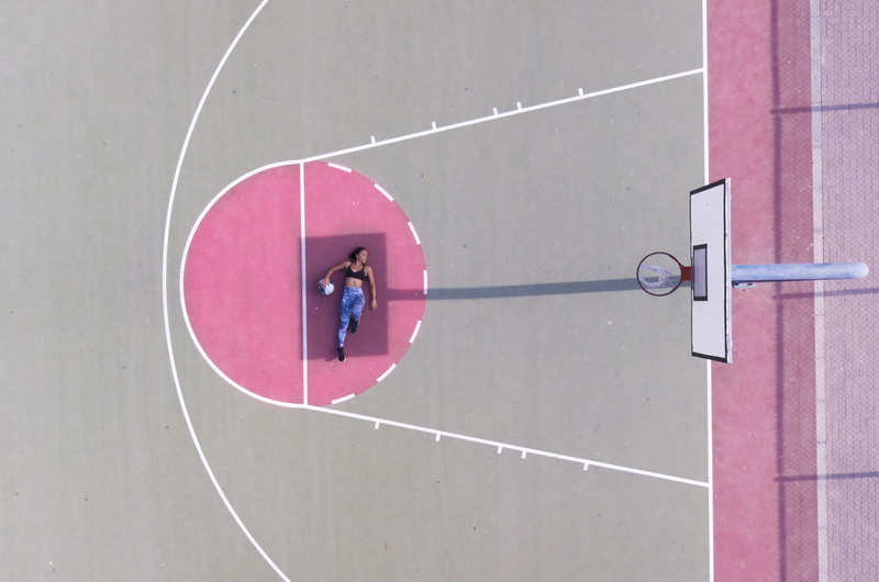 no people, building exterior, woman, protection, built structure, daylight, architecture, sport, drone view, sign, pink color, white color, aerial shot