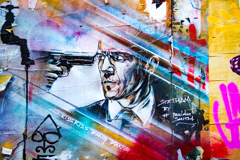 sculpture, full frame, painting, male likeness, drawing, man, wall - building feature, outdoors, built structure, gun, statue, mural, architecture, multi colored