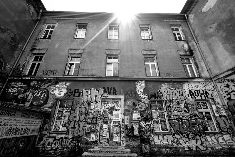 low, grayscale, low angle view, built structure, building, sunlight, street art, outdoors, day, building exterior, architecture, window, paint, black and white