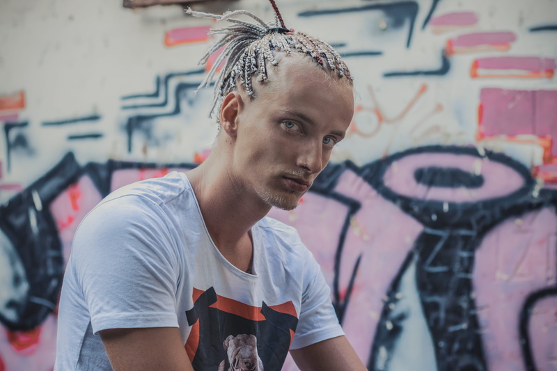people, male fashion, wall - building feature, portrait, tshirt, front view, man, grafitti, focus on foreground, leisure activity, creativity, real people