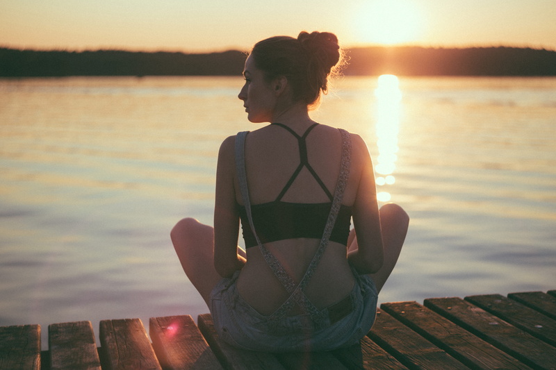 women, body, tranquility, wooden, hairstyle, 5K, young women, real people, lens flare, outdoors, looking at view, facing, sitting, brown, dock, waterfront