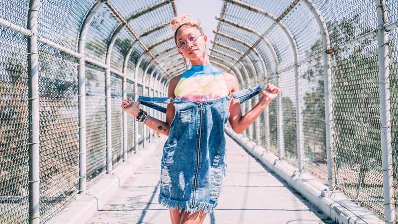 built structure, woman, motion, portrait, sport, city, daytime, young adult, front view, clothing, standing, adult, path, walkway, denim, bridge, hippie