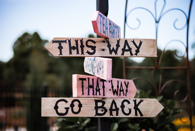 focus on foreground, alice, information sign, communication, mad, party, outdoors, signages, western script, tea, pole, go, 4K, capital letter, road sign