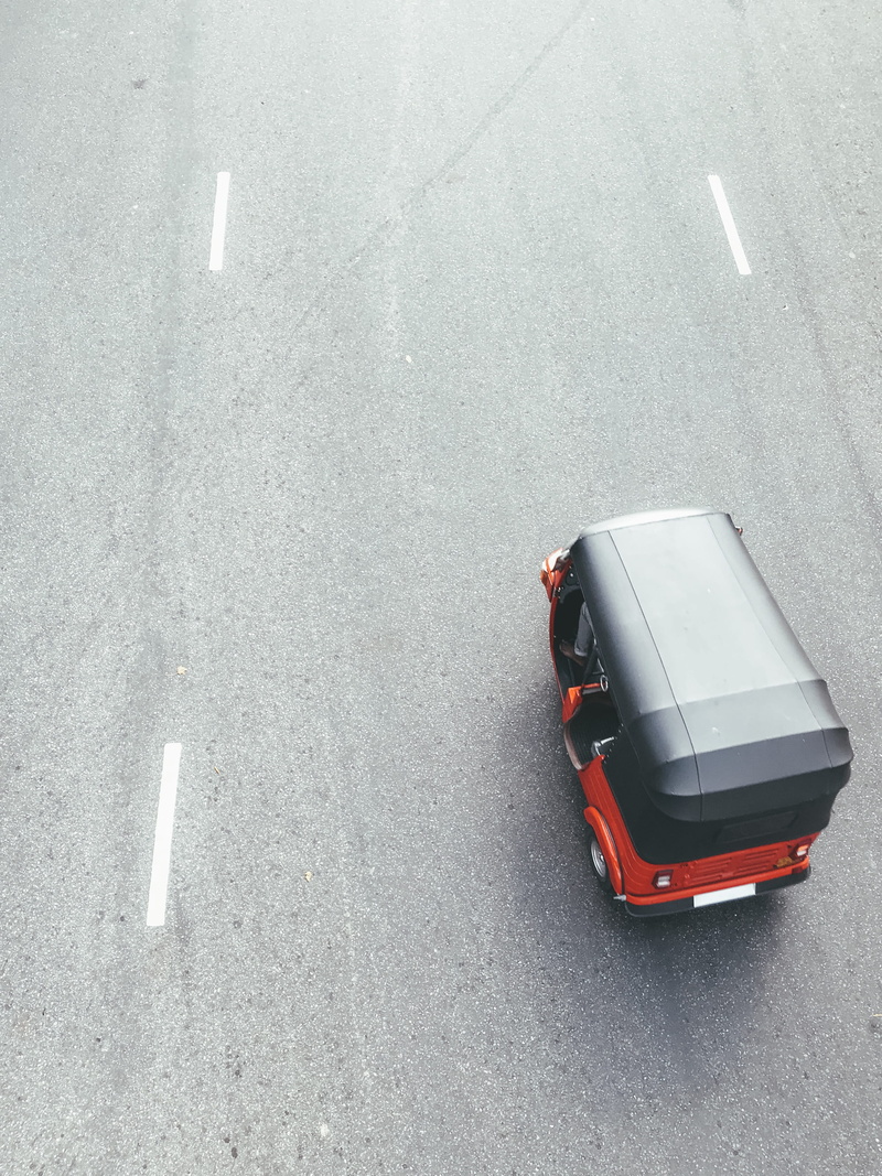 slope, spoke, wheel, dirt road, land vehicle, white color, 2K, car, high angle view, no people, day, black, red, van, street, sign, automobile, caravan