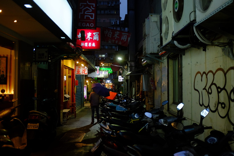 text, communication, transportation, machine, script, building, outdoors, bike, sign, tarmac, path, alley, non-western script, walkway, town, asphalt, spoke