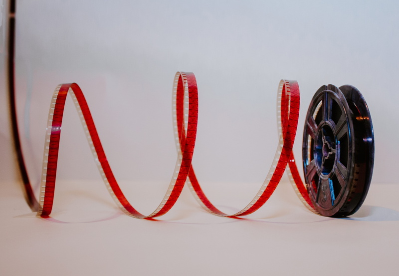 studio shot, no people, white background, red, 8mm, indoors, movies, 8mm film, brown, close-up, rope, furniture, chair, machine, filmrol, sport, communication