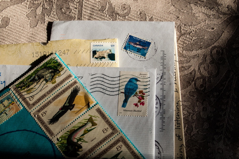 still life, directly above, post, stamp, send, finance, newspaper, postage, message, mail, human representation, correspondence, assorted, high angle view
