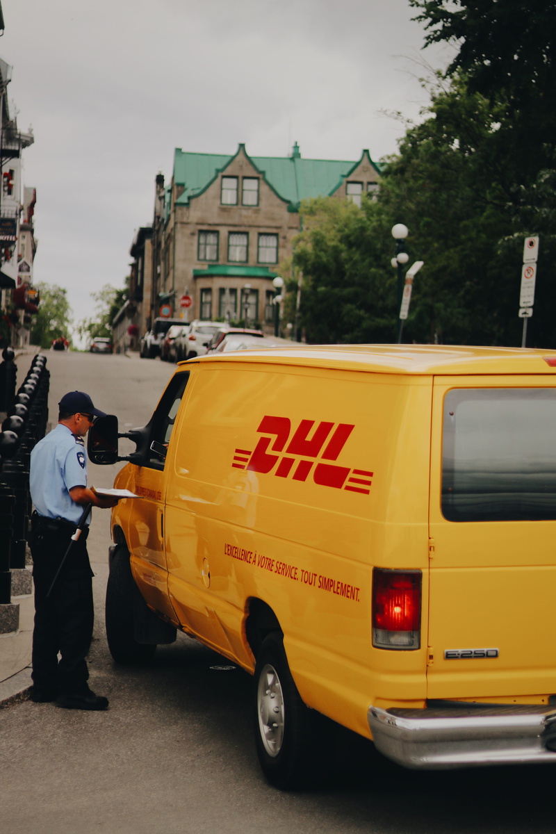 uniform, dhl, male, man, mode of transportation, 5K, city, company, postal, car, one person, standing, men, outdoors, land vehicle, road, occupation, travel